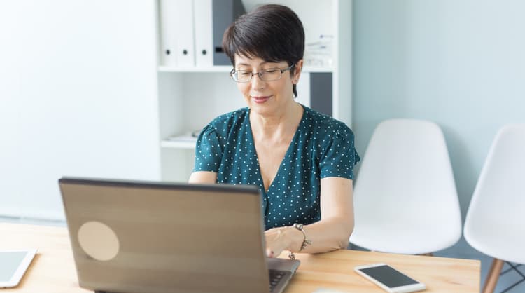 middle aged woman working on laptop