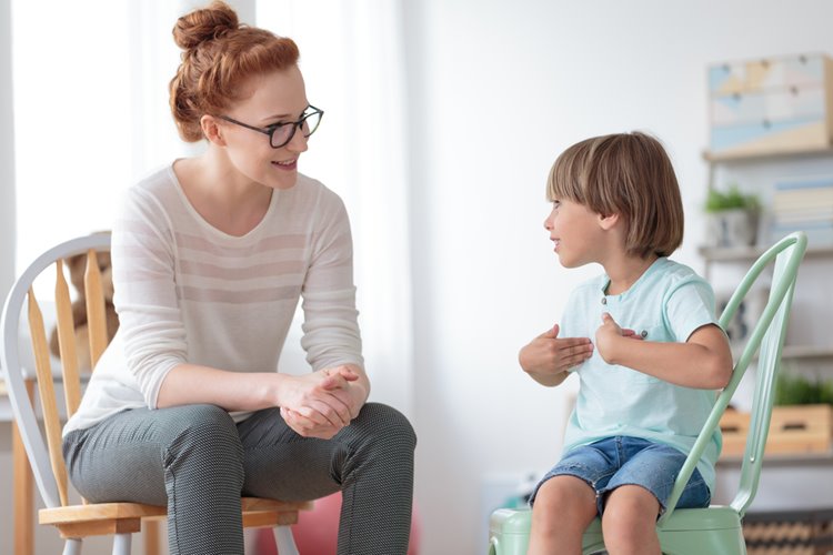 child counsellor talking to young boy