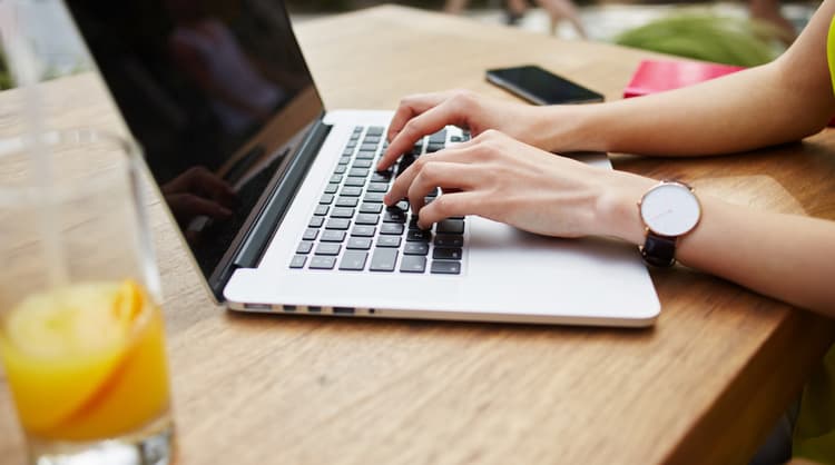 woman typing on laptop