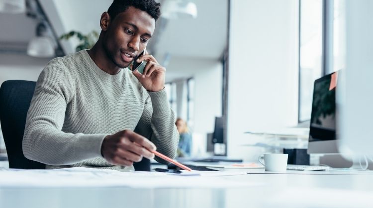 man on the phone looking at documents