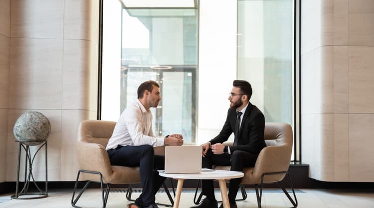 two men deep in discussion at the lobby