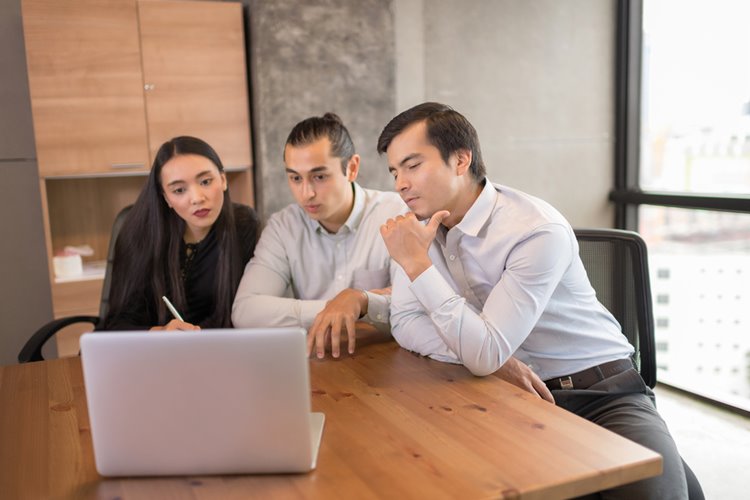 coworkers working on laptop