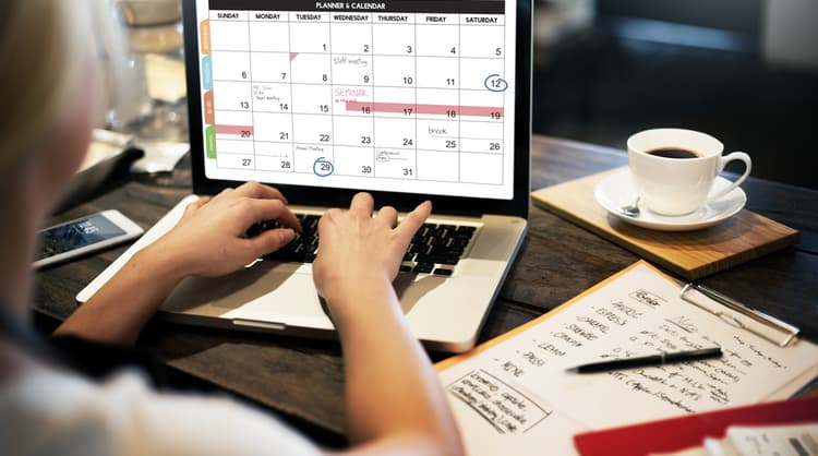 woman planning calendar on laptop