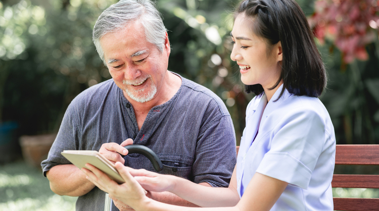 asian woman carer with asian man patient