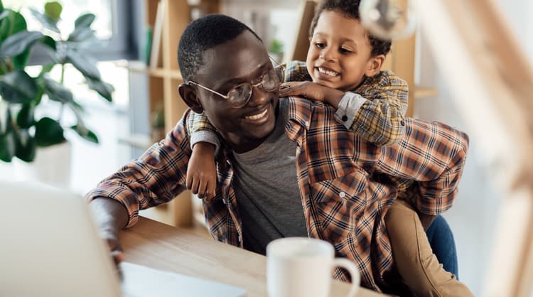 father working from home with son