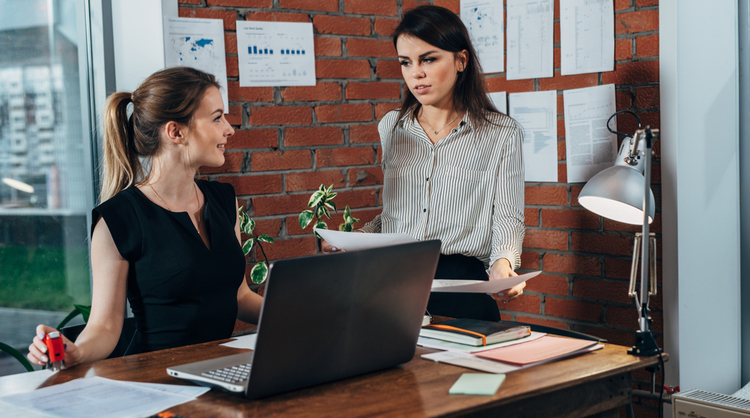 two women colleagues talking