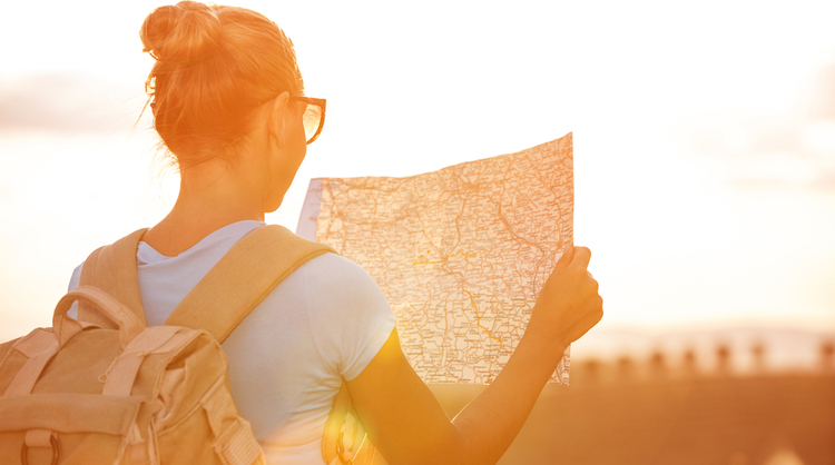 young woman looking at world map