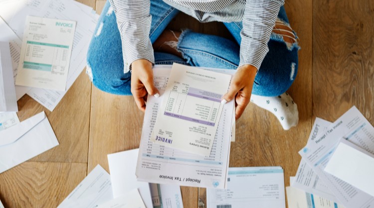 woman looking over payment documents