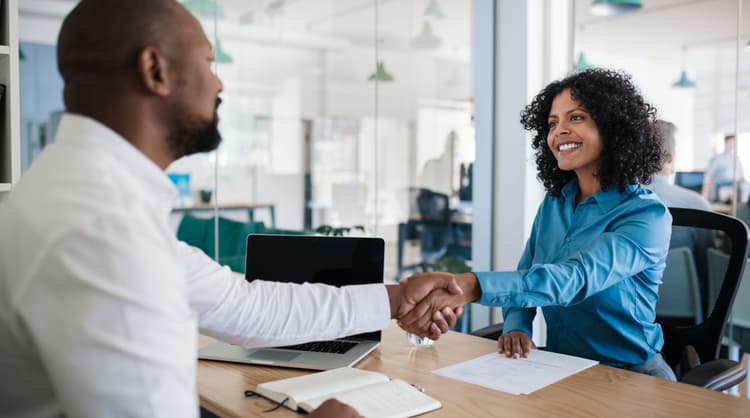 manager and new onboarding employee shaking hands