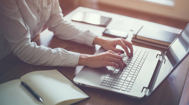 woman typing on laptop