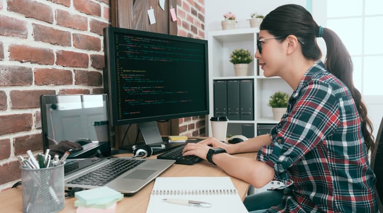 woman software engineer working on desktop computer