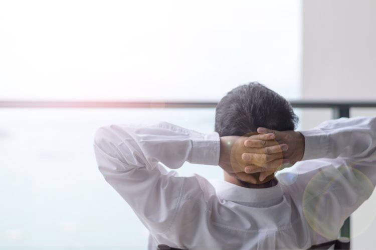 business man relaxing outside of balcony