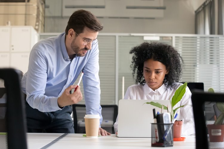 mentoring session between male boss and woman employee