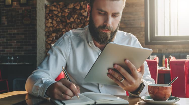 young bearded man studying online