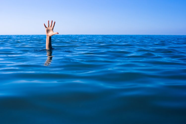 hand up by a person drowning into sea