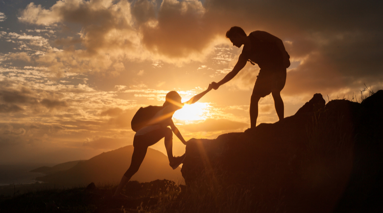 hikers supporting each other