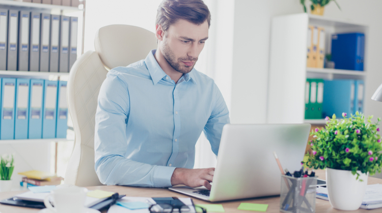 male manager working hard on his laptop