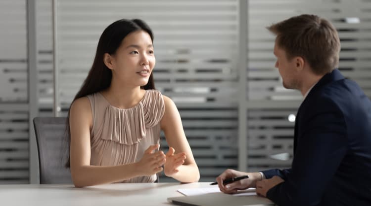 asian woman speaking with boss