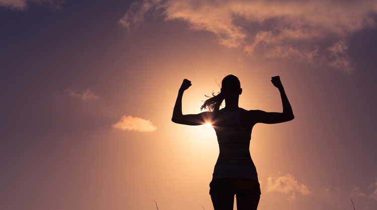 confident woman with arms up