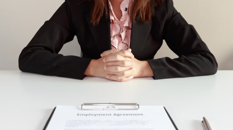 woman sitting with hands clasped interview process