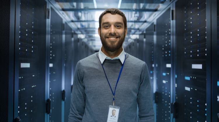 male IT professional smiling at camera