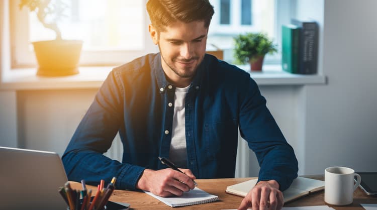 young man happily working from home