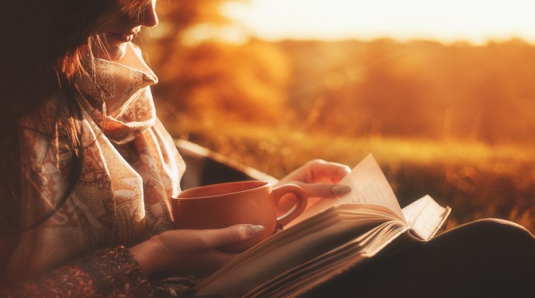 woman reading in autumn setting