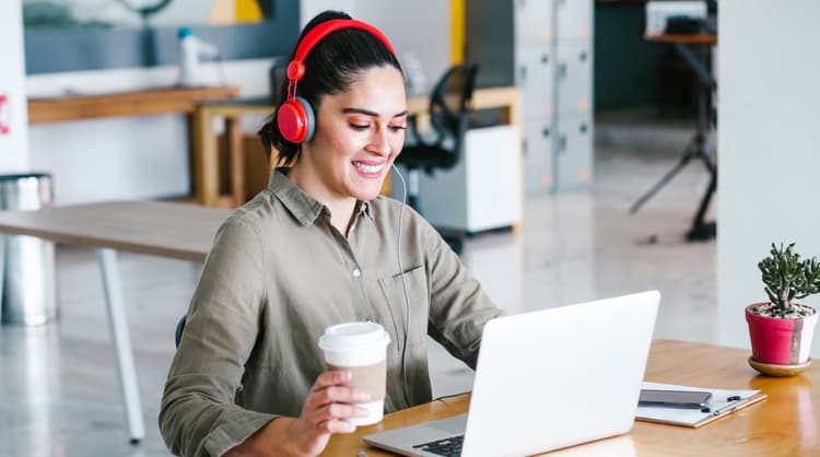 woman working on laptop looking happy