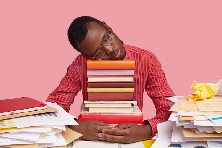 dark-skinned male asleep after intense studying session