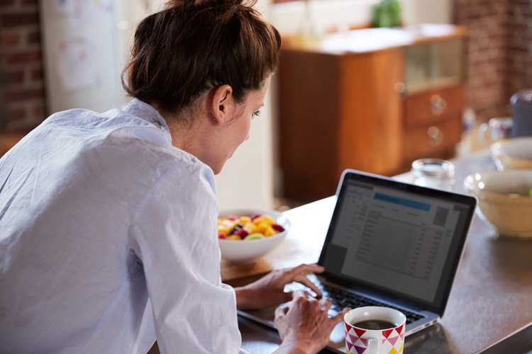 young woman doing research on laptop