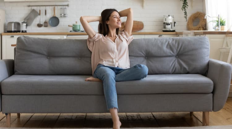 woman sitting relieved on the couch