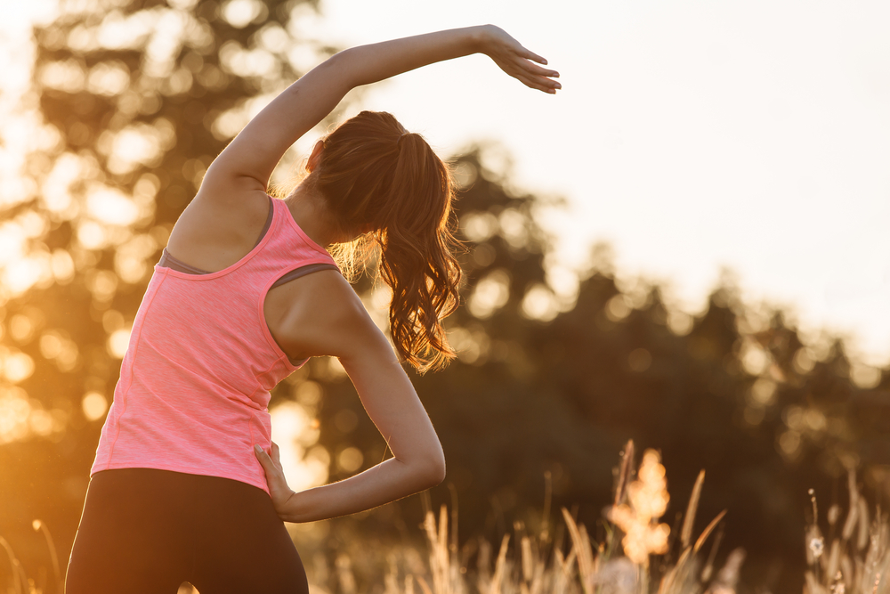 young woman stretching outside