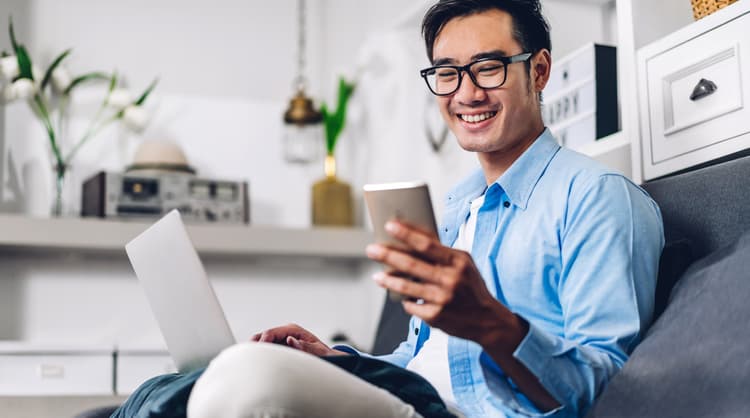 man smiling at smart phone