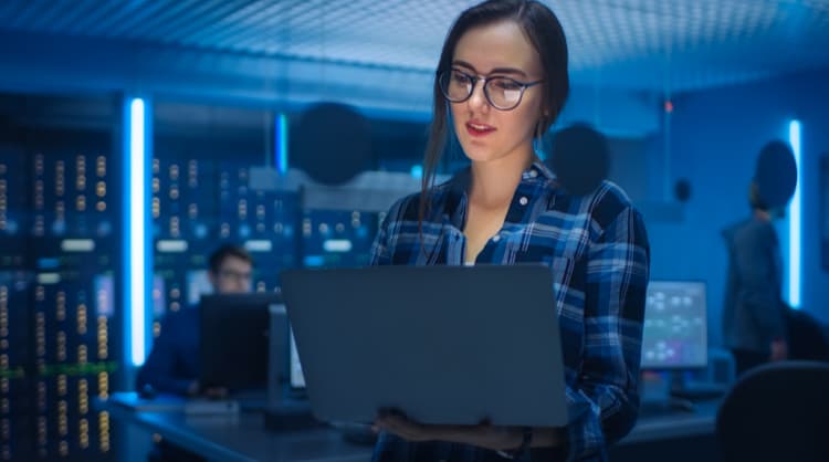 woman cyber security specialist working on laptop