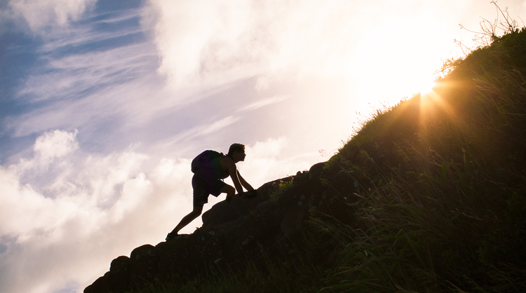 man climbing mountain