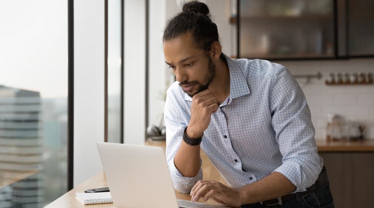 man looking at laptop screen intently