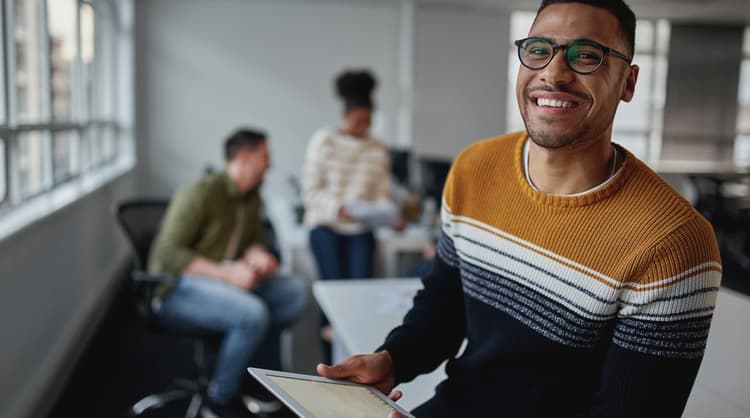 smiling man working in tech