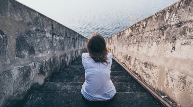 woman sitting alone on steps