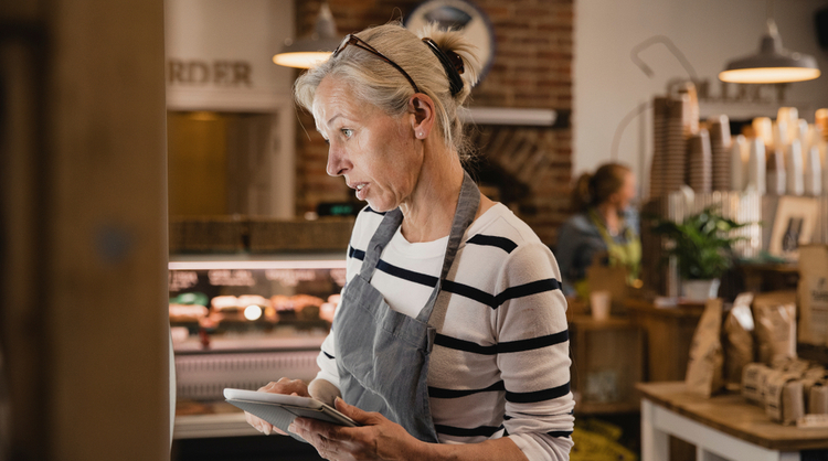 woman in her 50s working at cafe