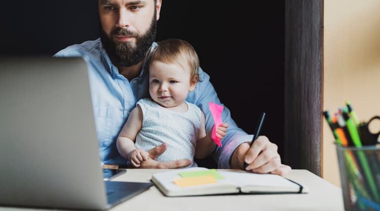 father studying online with toddler