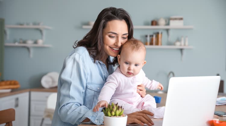 young mother working from home with baby