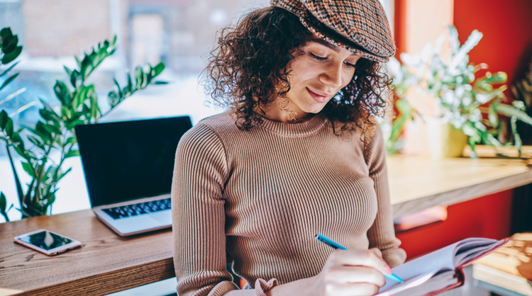 young woman writing her to-do list