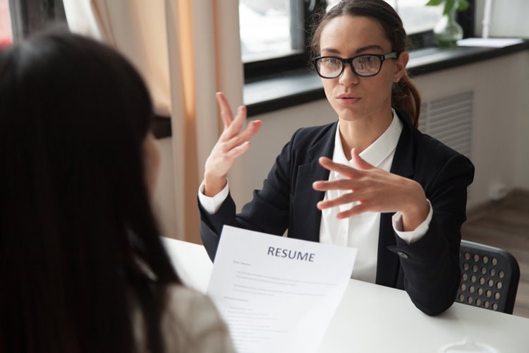 young woman answering questions during job interview