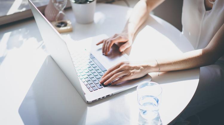 woman doing research on laptop