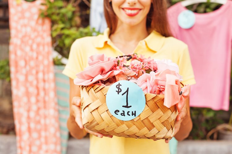 woman selling unwanted items at garage sale