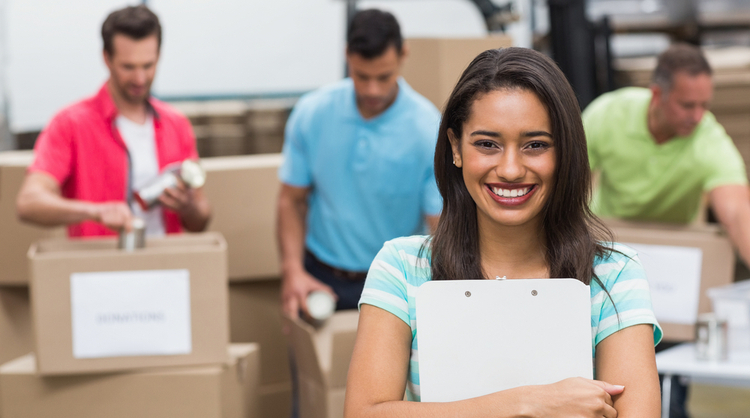 young ethnic woman holding clipboard and smiling