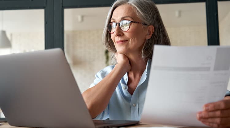 middle aged woman looking at laptop