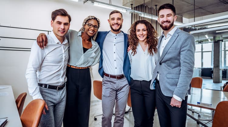 all colleagues smiling and posing for a photo