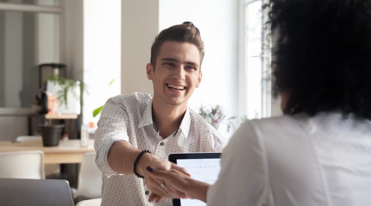 happy male client shaking woman advisor's hand