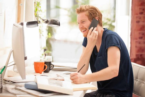 ginger haired man talking on phone